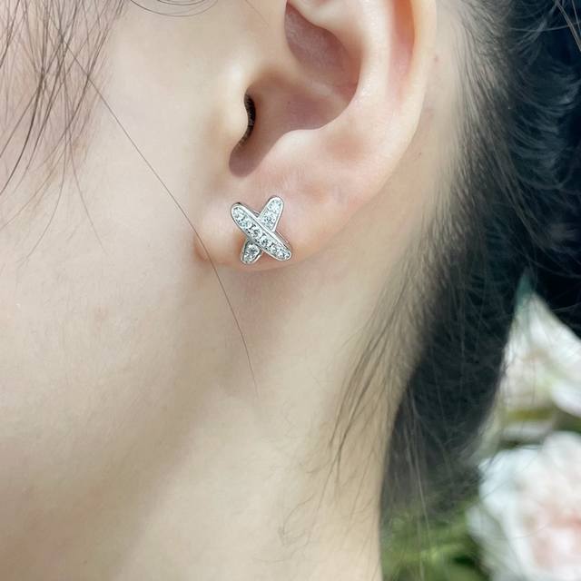 V gold with flying butterfly earplugs. Chaumet cross-shaped diamond stud earring