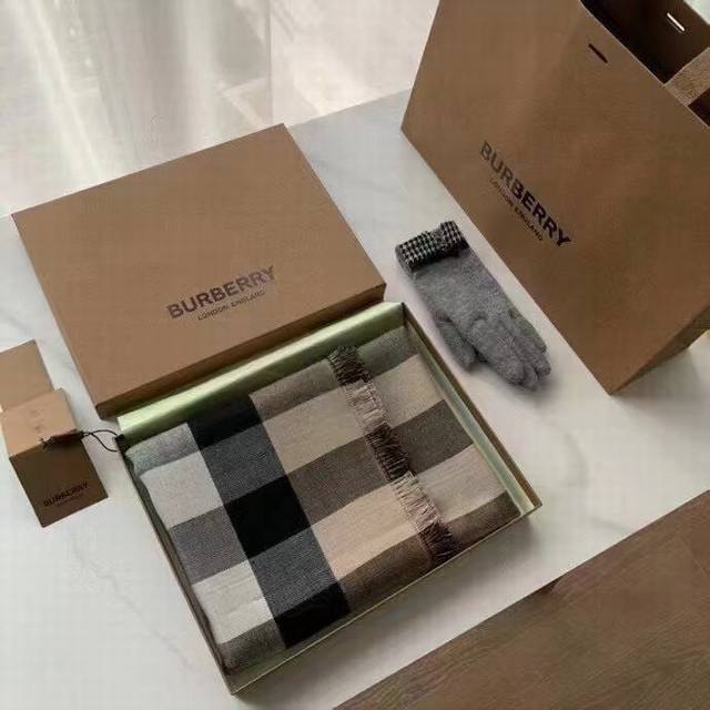 Welsh Check Shawl This lightweight scarf is crafted in Italy from checked cashm