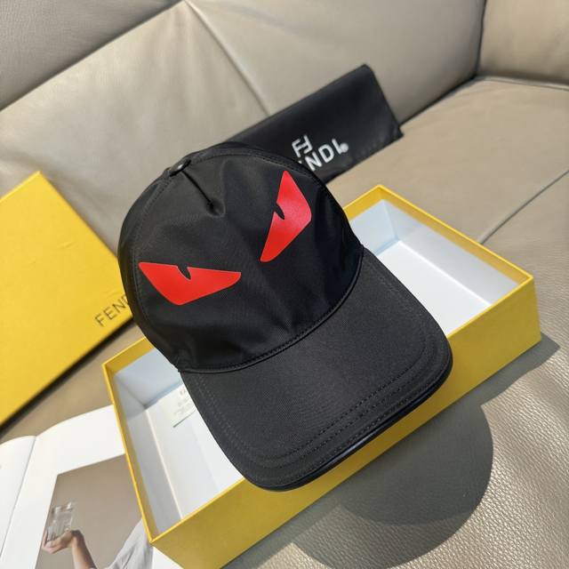 comes with a box bag. This new Fendi baseball cap features a "little monster" l