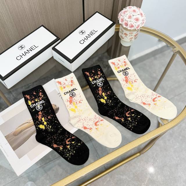 Comes in a box of four pairs of Chanel's popular mid-calf socks in the tall ver