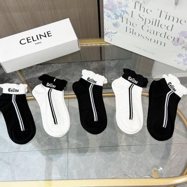 Comes with a box of five pairs of Celine's popular boat socks in the tall versi