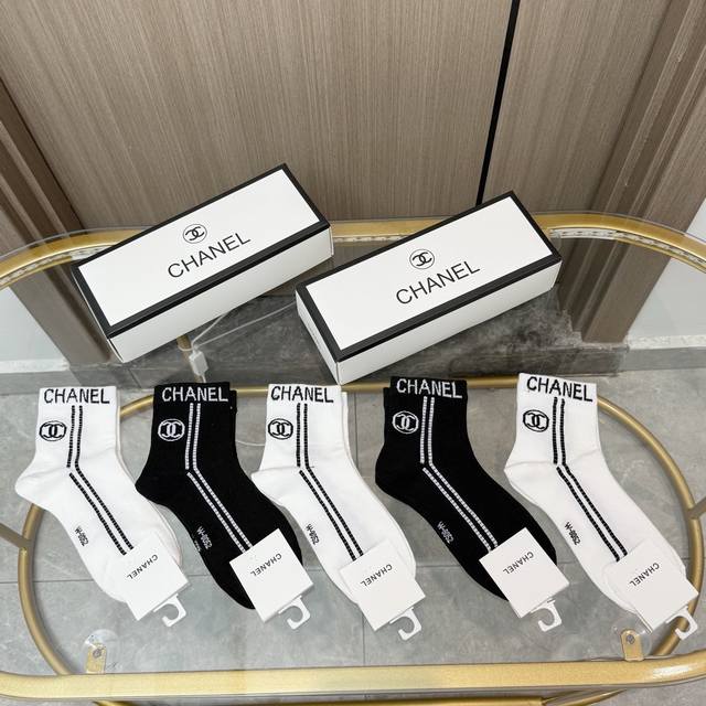 Comes with a box of five pairs of Chanel's popular mid-calf socks in the tall v