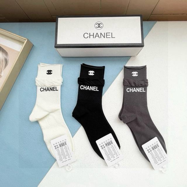Comes with a box of three pairs of Chanel's popular mid-calf socks in the tall