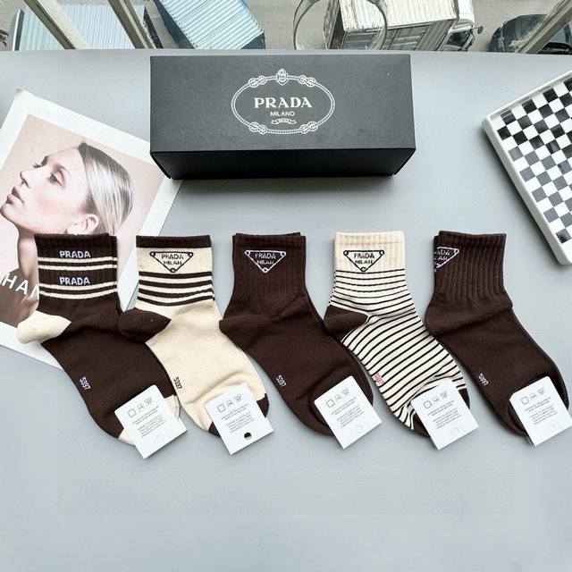 Comes with a box of five pairs of Prada's popular mid-calf socks in the tall ve
