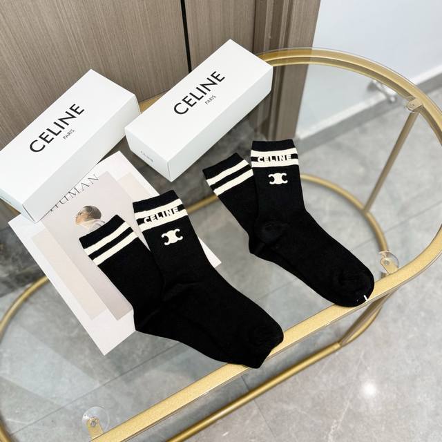 Comes with a box of two pairs of Celine's popular mid-calf socks in the tall ve