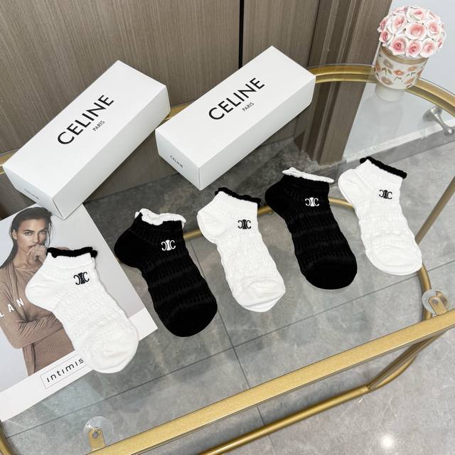 Comes with a box of five pairs of Celine's popular boat socks in the tall versi