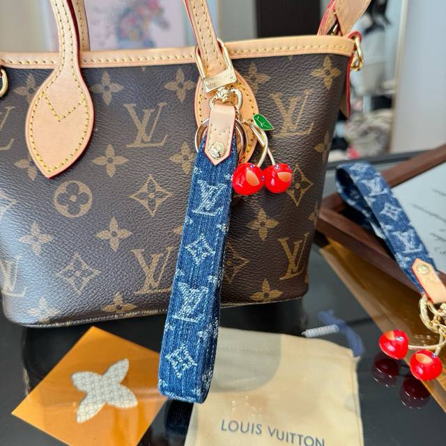 Lv keychain bag charm. The Lv Xtm Denim Cerise Dragonne bag charm is part of the