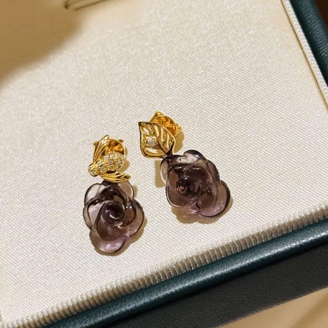 A6376 D's new asymmetrical amethyst rose, bee, and leaf stud earrings highlight