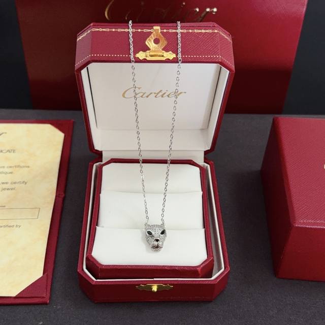 Cartier's high-end custom diamond-encrusted panther head necklace features a cl
