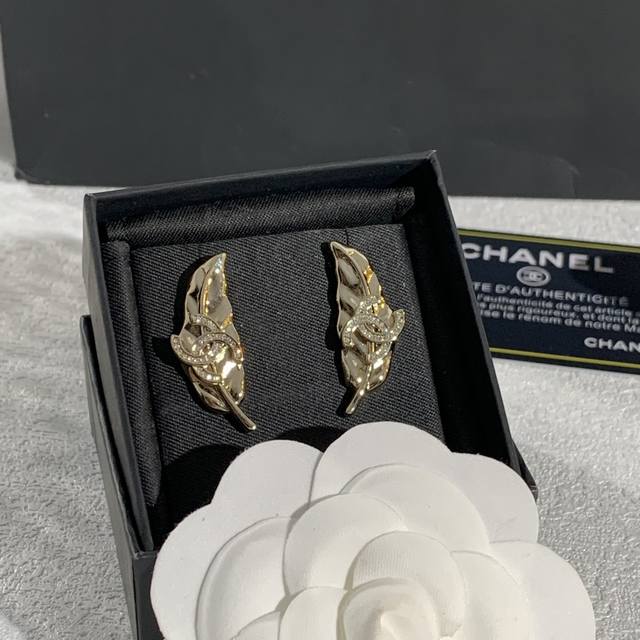 Chanel's leaf-design earrings, inspired by natural leaves, feature flowing line