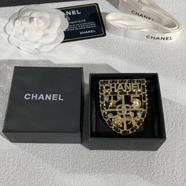 The Chanel shield brooch is a classic design. For example, the 1994 autumn mode