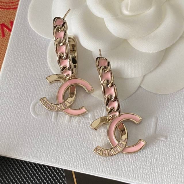 Chanel 25B pink letter cord hoop earrings are embellished with pink glass on one