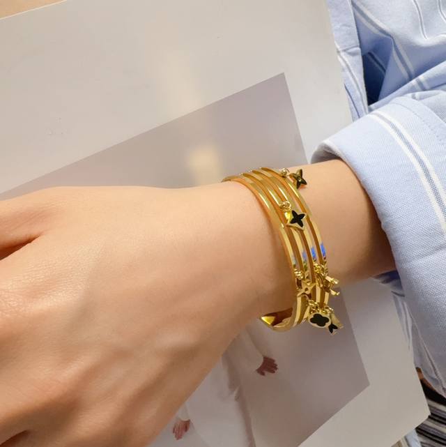 New, original, Lv-style, hollow-carved bracelet with multiple accessories. Made