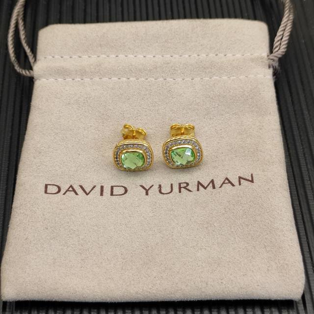 David Yurman 7mm gold square diamond earrings with green diamond as the main sto