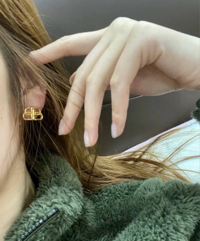 Balenciaga's new high-end earrings are meticulously crafted with a signature log