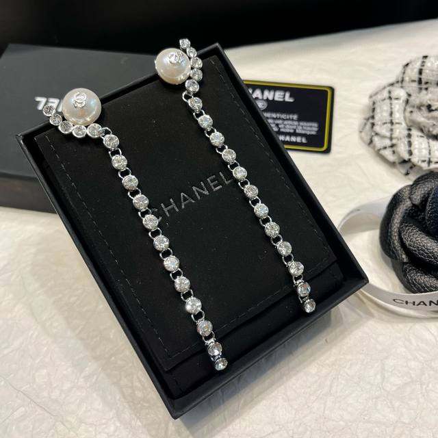 Chanel's latest silver round diamond long pearl earrings are made of brass. They