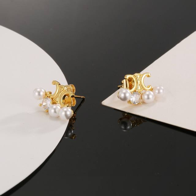 Celine's new pearl earrings are a classic gold colorway, featuring a highly reco