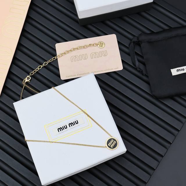 Miumiu candy-colored enamel button necklaceMiumiu's logo design elements, minima