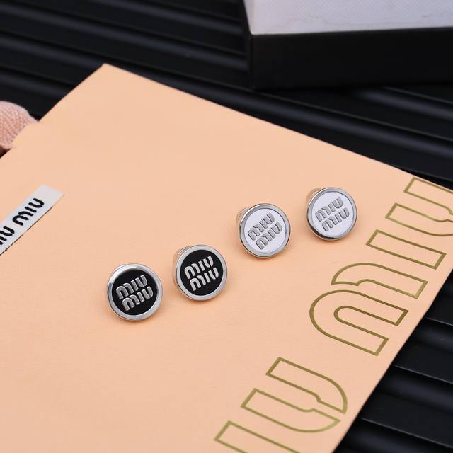 Miumiu enamel button letter earringsMiumiu's logo design elements, minimalism, n
