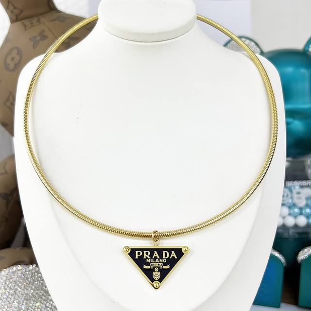Gold Prada Triangle Choker - A hot new product. The choker features a pendant ad