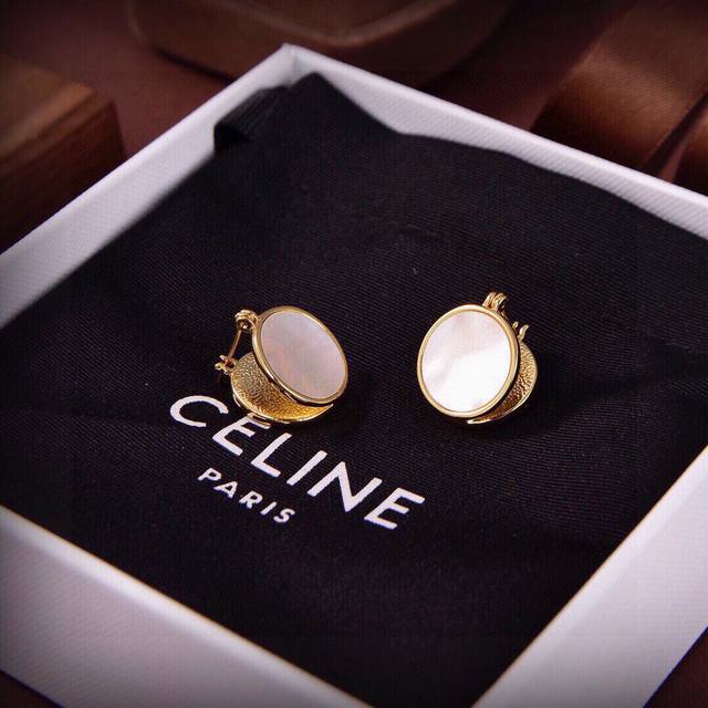 Celine's new gold and white mother-of-pearl earrings feature a unique and distin