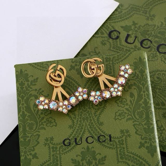 Gucci double G earrings, a signature element of the brand, are presented in a un