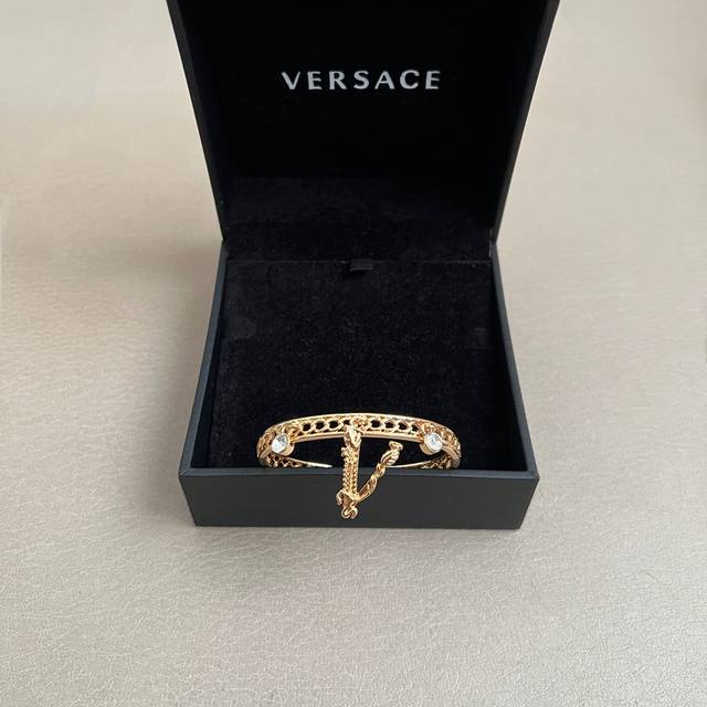 The Versace bracelet's logo is Medusa, the Gorgon from mythology, representing f