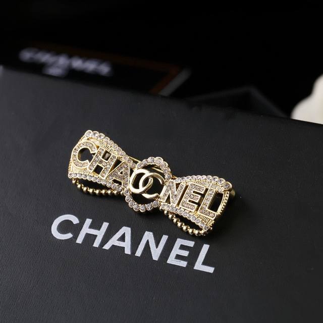Chanel's new bow-adorned, fully rhinestone-encrusted double C brooch. Every deta