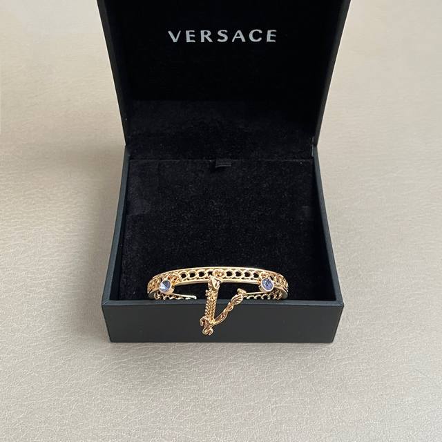 The Versace bracelet's logo is Medusa, the Gorgon from mythology, representing f