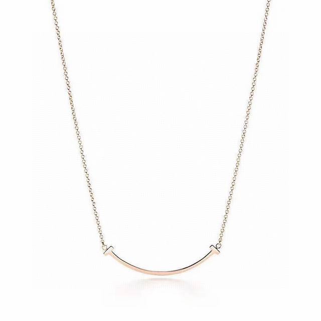 Exquisitely crafted medium-sized Tiffany & Co. smiley double T necklace, featuri