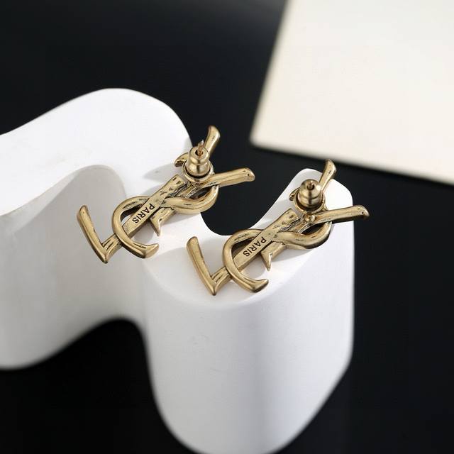 Yves Saint Laurent earrings, original brass material. Founded in 1961, Yves Sain