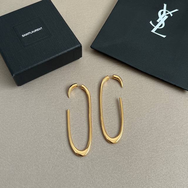 Saint Laurent earrings with a superb metallic texture, made of original brass, e