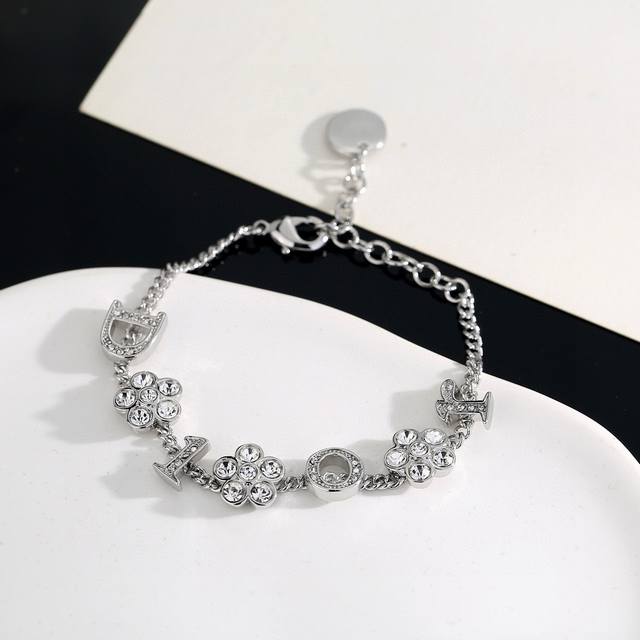Dior monogram and flower necklace/bracelet. The simple design is undeniably styl