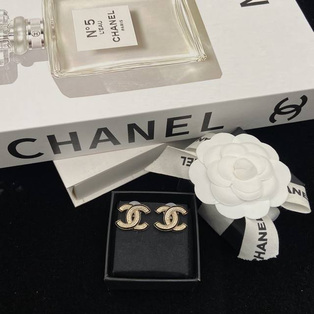 Chanel Black Enamel Gold Double C Stud Earrings The black and gold combination e