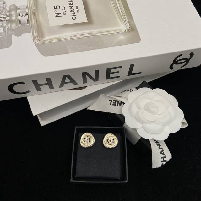 Chanel's new round brushed round stud earrings Ddd. They have a vintage feel, ar