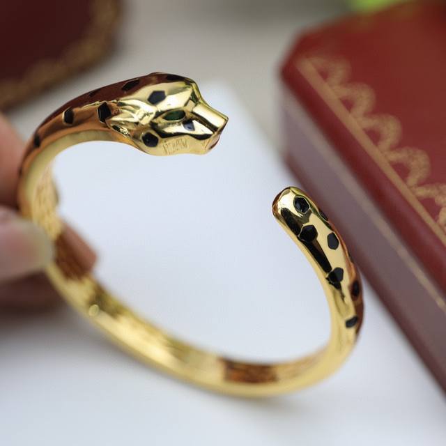 A bold, black panther bracelet in 18K gold plating. Featuring round brilliant-cu