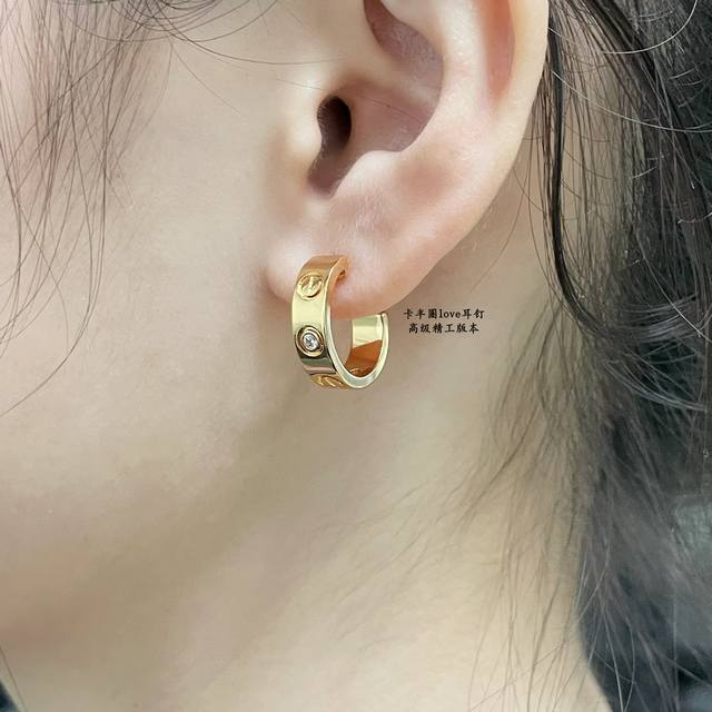 Cartier Love half-hoop earrings in V gold, a classic design with UFO-shaped ear