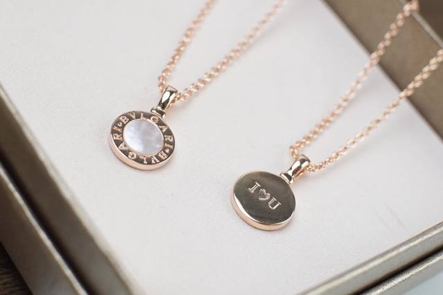 Bvlgari mother-of-pearl necklace, combining white mother-of-pearl with the "IU"