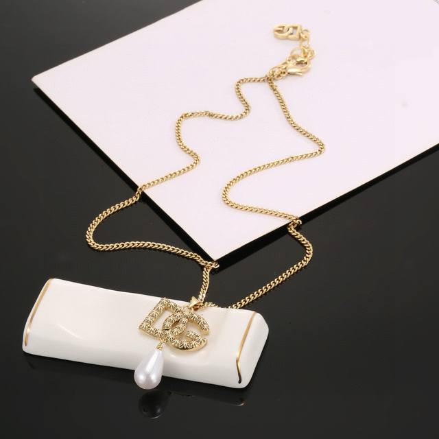 D&G Dolce & Gabbana logo pendant necklace adds a touch of glamour and elegance t