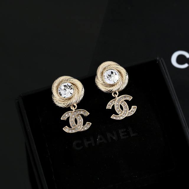 Chanel stud earrings flatter the face shape. The gold metal trim gives them a my