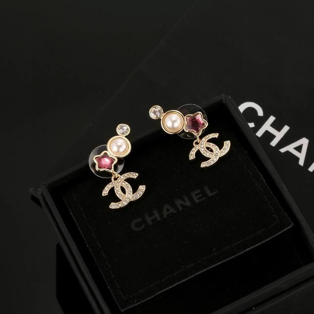 Chanel colorful star stud earrings flatter the face shape. The gold metal trim g