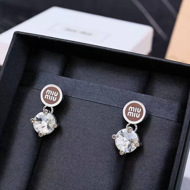 Miumiu Enamel Button Diamond Earrings. Featuring Miumiu's logo design, this mini