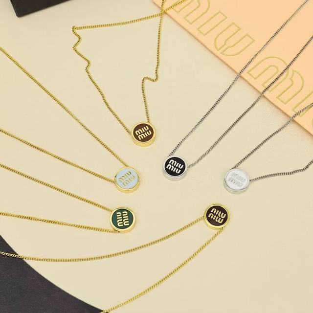 Miumiu Candy-Colored Enamel Button Necklace. Featuring Miumiu's logo design elem