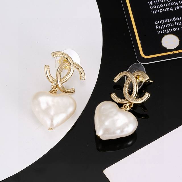 Chanel light gold heart-shaped earrings are a trendy early spring style. Whether