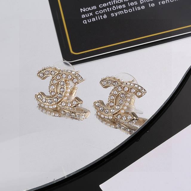 Chanel light gold earrings are a trendy early spring style. Whether you have a r