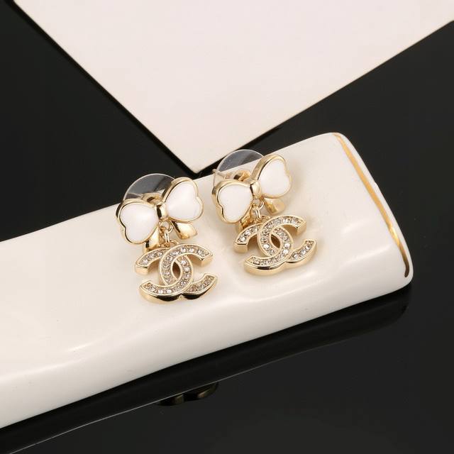 Chanel bow earrings flatter the face shape. The gold metal trim gives them a mys