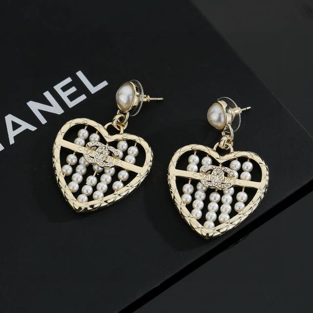 Chanel light gold heart-shaped earrings are a trendy early spring style. Whether