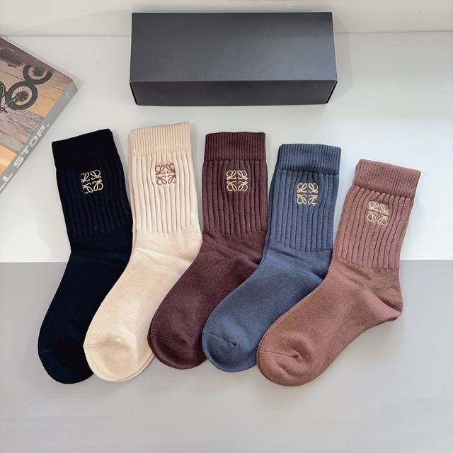 A box of 5 pairs of Loewe cashmere embroidered knee-high socks with packaging. A
