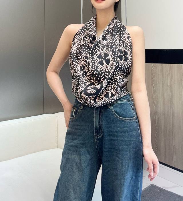 A truly rare vintage Chanel silk scarf featuring a cleverly designed pattern of