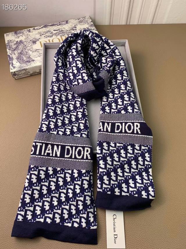 Dior. This monogrammed knitted long scarf is already available in domestic bouti